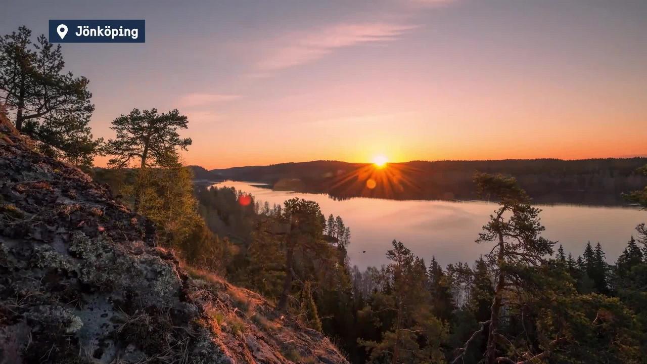 Sunlight over cliffs and lake in a forest in Jönköping