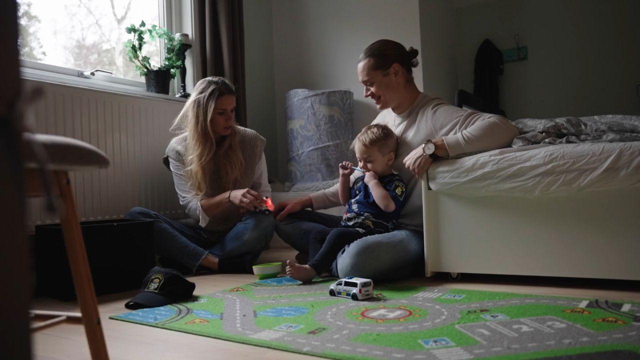 Two parents playing with their toddler.