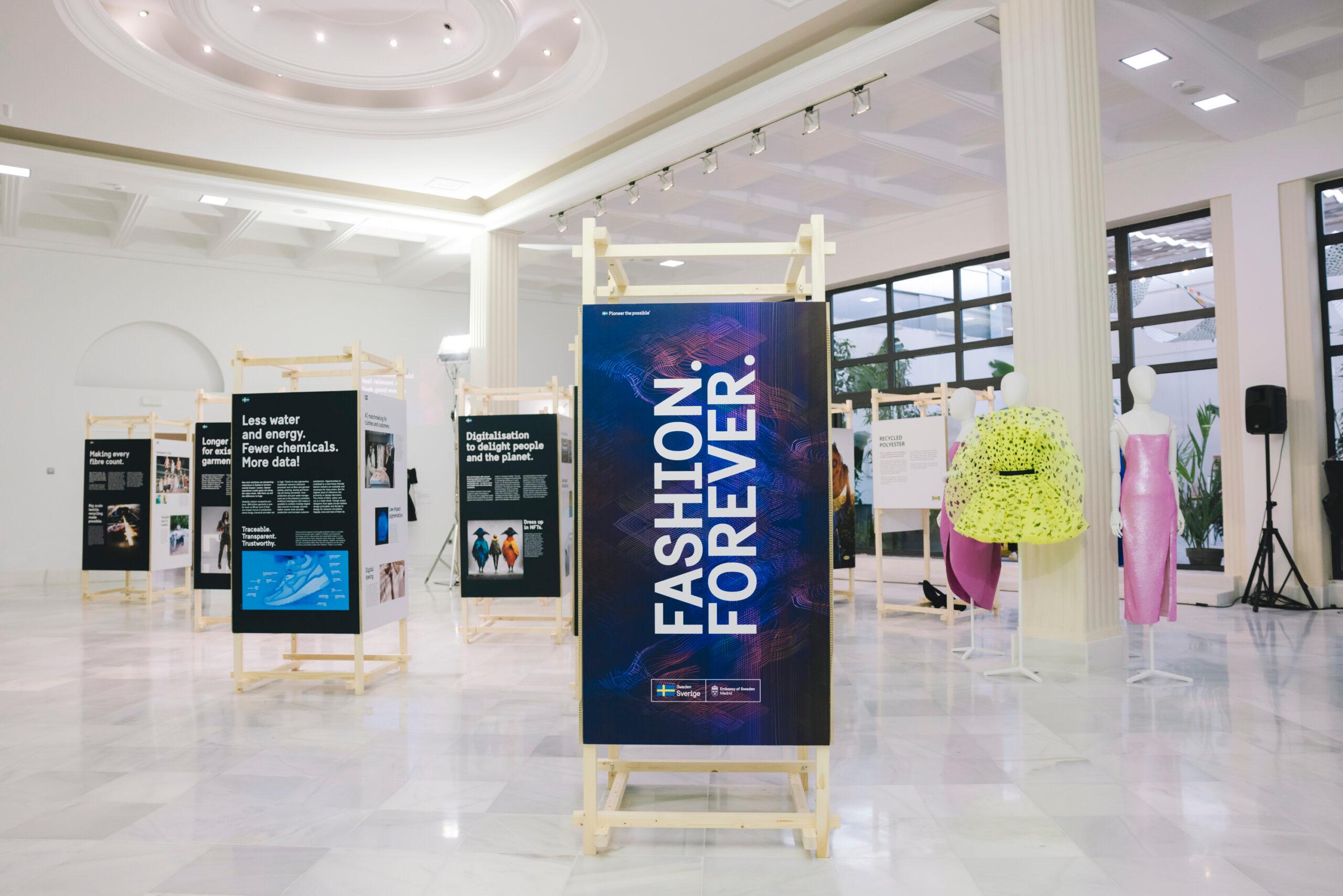 The exhibition and dresses showcased in a room with marble floors.