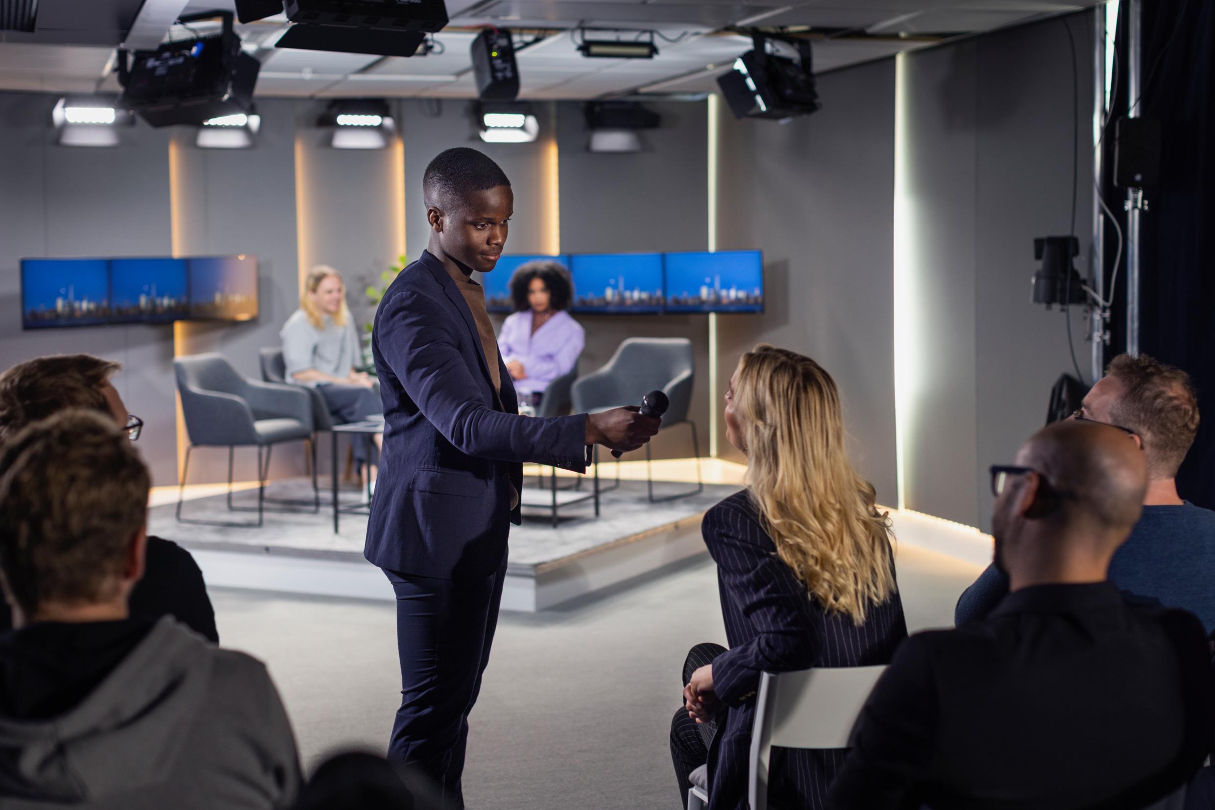 A television studio where a person is being interviewed.