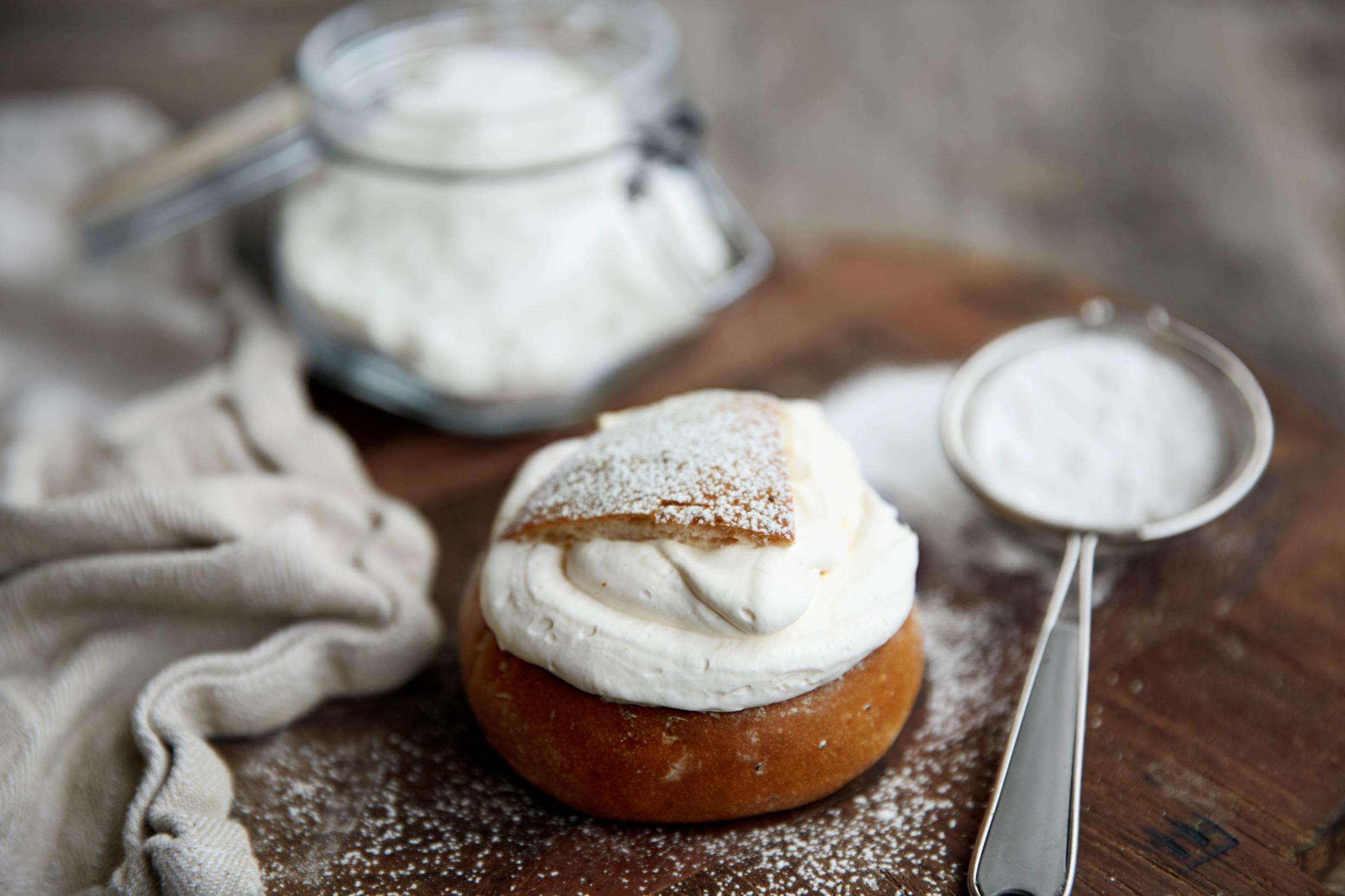 A freshly baked semla with powdered sugar.