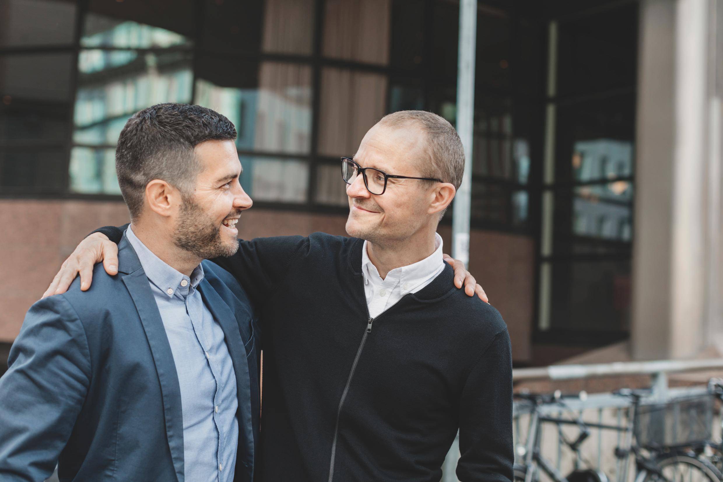 Two male friends looking at each other.