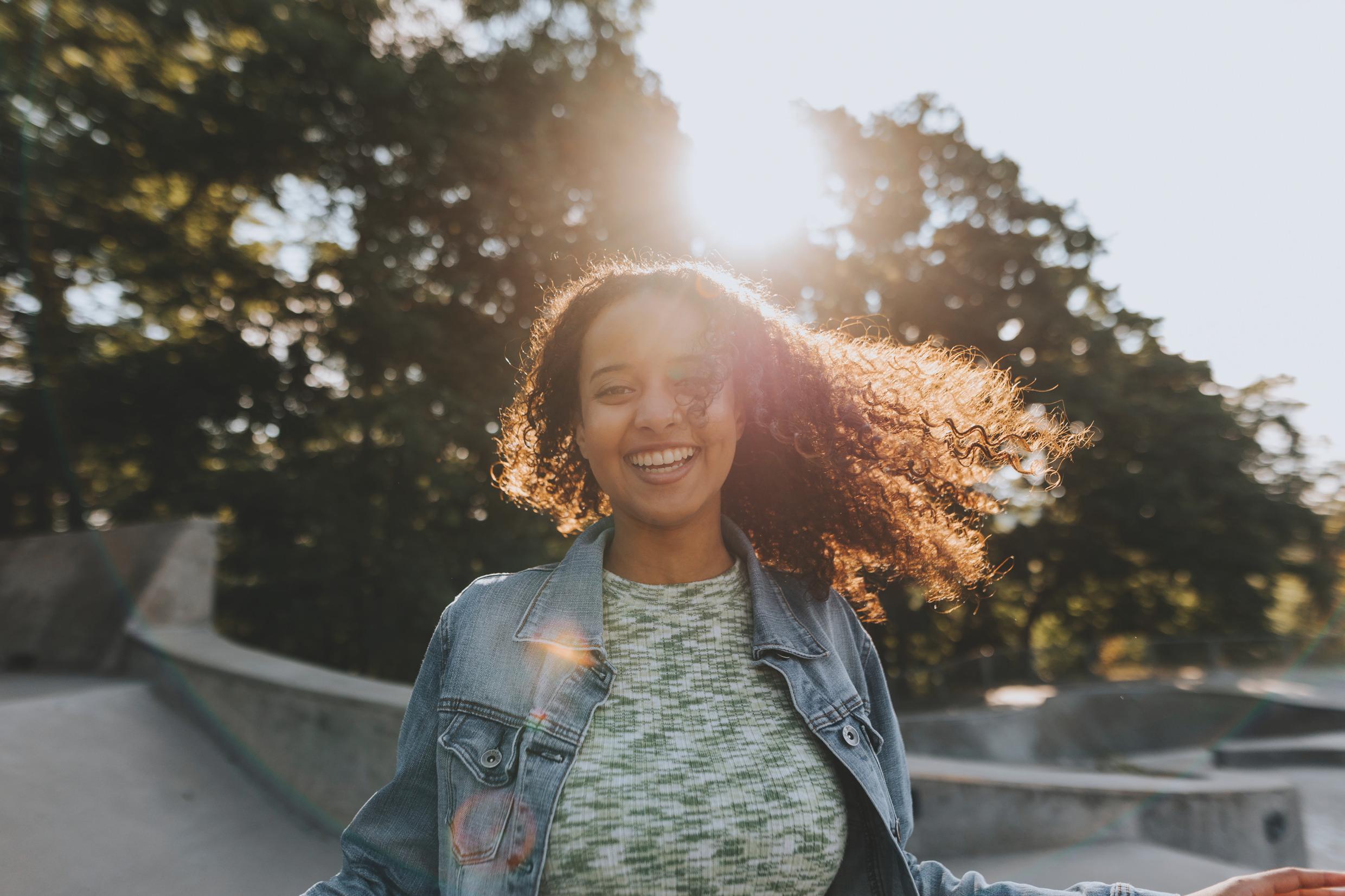 Portrait of a young, happy girl in a skate park.