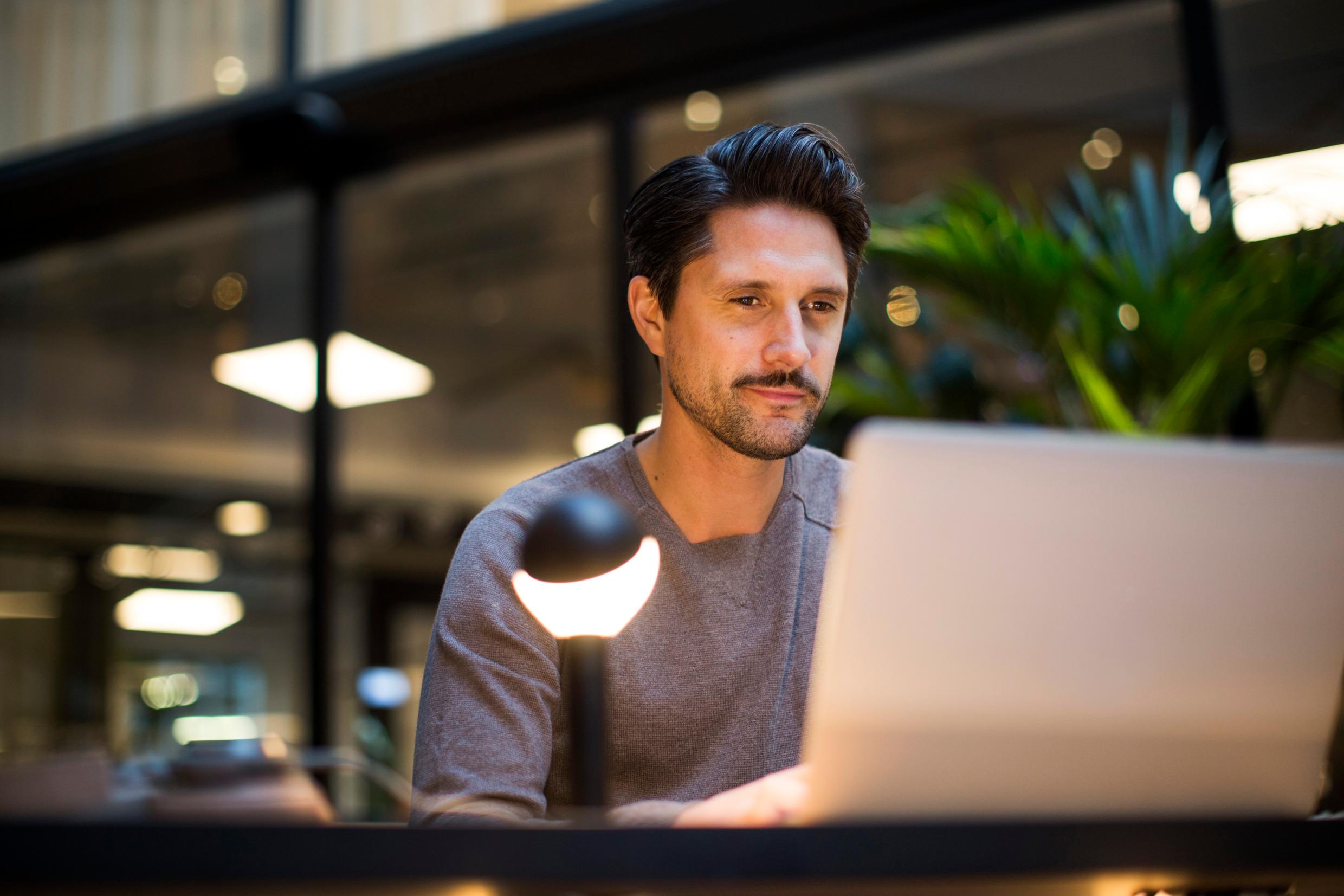 A person reading on a computer.