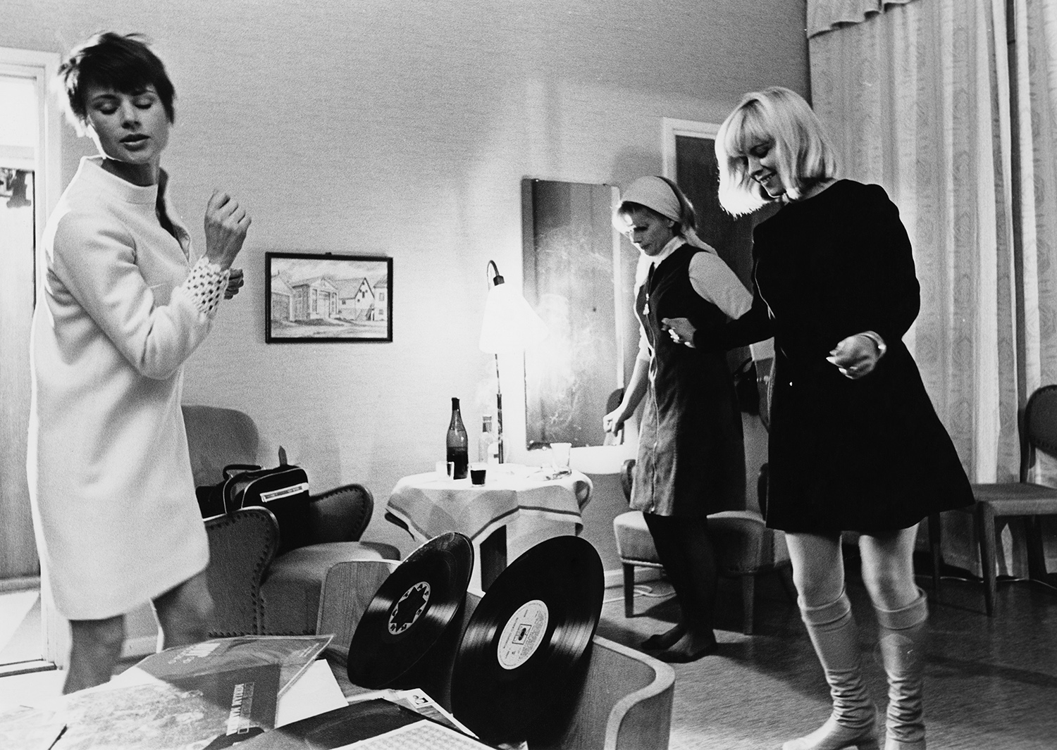 Three women in the 1960s dancing to music.
